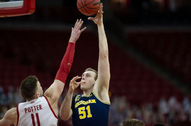 February 14, 2021: Michigan Wolverines guard Franz Wagner 21 shoots over the reach of Wisconsin Badgers forward Micah Potter 11 during the NCAA, College League, USA basketball game between the Michigan Wolverines and the Wisconsin Badgers at the Kohl Center in Madison, WI. CSM Madison United States of America - ZUMAc04_ 20210214_zaf_c04_083 Copyright: xJohnxFisherx