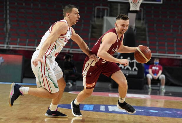 (210221) -- RIGA, Feb. 21, 2021 -- Kristers Zoriks (R) of Latvia vies with Vasil Bachev of Bulgaria during their FIBA EuroBasket 2022 qualifying basketball match in Riga, Latvia, Feb. 20, 2021. (Photo by Xinhua) (SP)LATVIA-RIGA-BASKETBALL-FIBA EUROBASKET 2022-LATVIA VS BULGARIA EdijsxPalens 