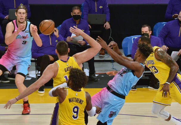 Miami Heat forward Jimmy Butler passes the ball to center Kelly Olynyk past Los Angeles Lakers center Marc Gasol during the second half at Staples Center in Los Angeles on Saturday, February 20, 2021. The Heat defeated the Lakers 96-94.  LAP2021022002 JIMxRUYMEN