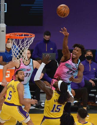 Miami Heat guard Jimmy Butler scores over Los Angeles Lakers center Montreal Harrell during the second half at Staples Center in Los Angeles on Saturday, February 20, 2021. The Heat defeated the Lakers 96-94.  LAP2021022005 JIMxRUYMEN
