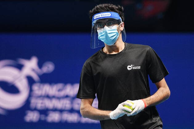(210222) -- SINGAPORE, Feb. 22, 2021 -- A ball boy reacts during the men s singles first round match between Japan s Daniel Taro and India s Ramkumar Ramanathan at the Singapore Tennis Open in Singapore, Feb. 22, 2021. (Photo by Xinhua) (SP)SINGAPORE-TENNIS-SINGAPORE OPEN-MEN S SINGLES ThenxChihxWey 