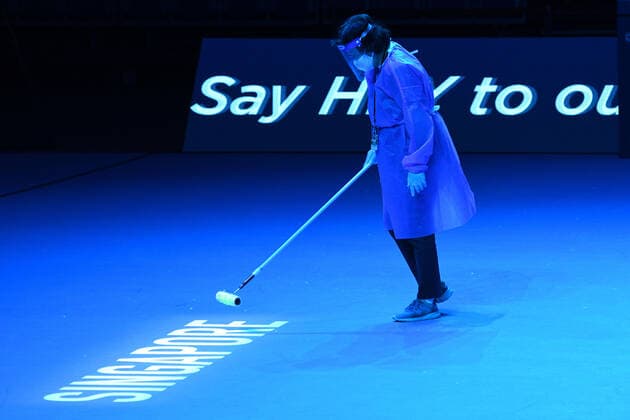 (210222) -- SINGAPORE, Feb. 22, 2021 -- A worker cleans the court before the men s singles first round match between Japan s Daniel Taro and India s Ramkumar Ramanathan at the Singapore Tennis Open in Singapore, Feb. 22, 2021. (Photo by Xinhua) (SP)SINGAPORE-TENNIS-SINGAPORE OPEN-MEN S SINGLES ThenxChihxWey 
