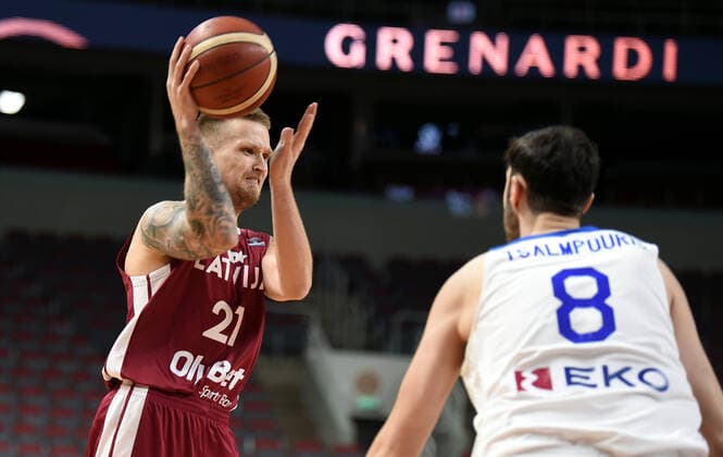 (210223) -- RIGA, Feb. 23, 2021 -- Aigars Skele (L) of Latvia competes during the FIBA EuroBasket 2022 qualifying basketball match between Latvia and Greece in Riga, Latvia, Feb. 22, 2021. (Photo by Xinhua) (SP)LATVIA-RIGA-BASKETBALL-FIBA EUROBASKET 2022 QUALIFIERS-LATVIA VS GREECE EdijsxPalens 