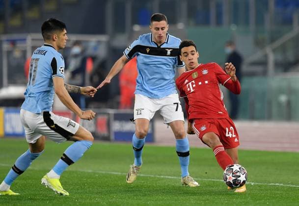 FOOTBALL CHAMPIONS LEAGUE SEASON 2020 2021 Round of 16 first leg 22 02 2021 Lazio Roma FC Bayern Muenchen Jamal Musiala r, FC Bayern Muenchen vs Andreas Pereira centre, Lazio Roma and Joaquin Correa l, Lazio Roma