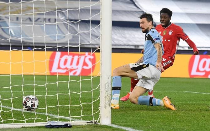 FOOTBALL CHAMPIONS LEAGUE SEASON 2020 2021 Round of 16 First leg 23 02 2021 Lazio Roma FC Bayern Muenchen Francesco Acerbi centre, Lazio Roma scores 0 4 own goal watched by Alphonso Davies right, FC Bayern Muenchen