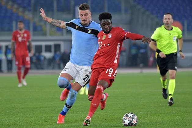 Sergej Milinkovic-Savic of SS Lazio and Alphonso Davies of FC Bayern Munchen compete for the ball during the Champions League round of 16 football match between SS Lazio and Bayern Munchen at stadio Olimpico in Rome (Italy), February, 23th, 2021. Photo Andrea Staccioli Insidefoto andreaxstaccioli