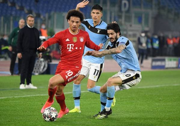 FOOTBALL CHAMPIONS LEAGUE SEASON 2020 2021 Round of 16 First leg 23 02 2021 Lazio Roma FC Bayern Muenchen Leroy Sane left, FC Bayern Muenchen vs Luis Alberto right, Lazio Roma and Joaquin Correa back, Lazio Roma.