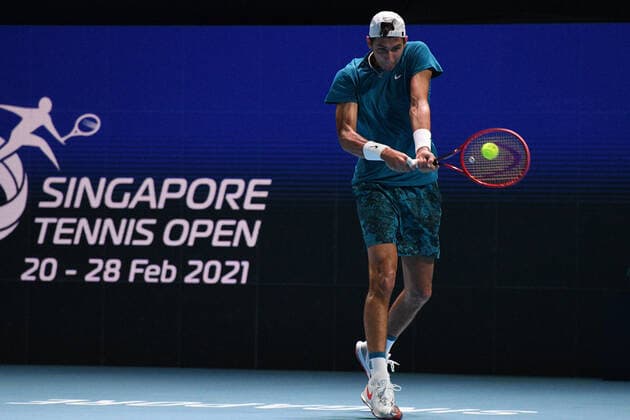 (210227) -- SINGAPORE Feb. 27, 2021 -- Alexei Popyrin hits a return during the men s singles semi-final match between Croatia s Marin Cilic and Australia s Alexei Popyrin at the Singapore Tennis Open tournament in Singapore on Feb. 27, 2021. (Photo by Xinhua) (SP)SINGAPORE-TENNIS-SINGAPORE OPEN-MEN S SINGLES ThenxChihxWey 