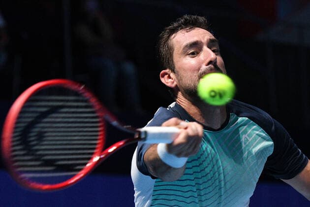 (210227) -- SINGAPORE Feb. 27, 2021 -- Marin Cilic hits a return during the men s singles semi-final match between Croatia s Marin Cilic and Australia s Alexei Popyrin at the Singapore Tennis Open tournament in Singapore on Feb. 27, 2021. (Photo by Xinhua) (SP)SINGAPORE-TENNIS-SINGAPORE OPEN-MEN S SINGLES ThenxChihxWey 