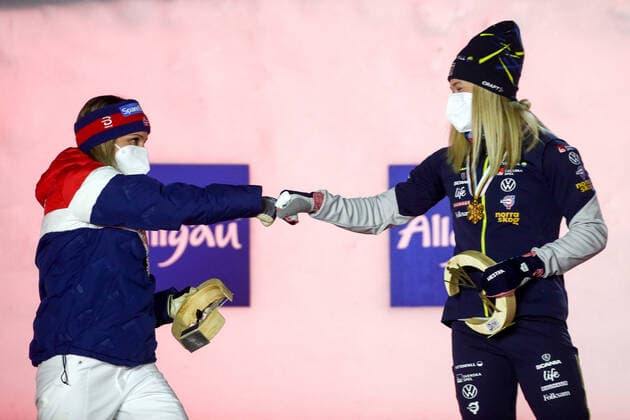 OBERSTDORF, GERMANY - FEBRUARY 27, 2021: Silver medalist Maiken Caspersen Falla (L) of Norway and gold medalist Jonna Sundling of Sweden bump fists during an award ceremony for the women s classic sprint event at the 2021 FIS Nordic World Ski Championships. Sergei Bobylev TASS  TS0F8078