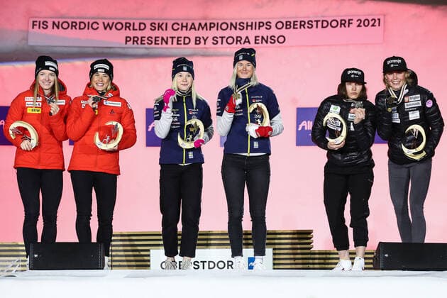 OBERSTDORF, GERMANY - FEBRUARY 28, 2021: Silver medalists Nadine Fahndrich and Laurien van der Graaff of Switzerland, Gold medalists Maja Dahlqvist and Jonna Sundling of Sweden and Bronze medalists Eva Urevc and Anamarija Lampic (L-R) of Slovenia pose for a photograph during an award ceremony for the women s team sprint event at the 2021 FIS Nordic World Ski Championships. Sergei Bobylev TASS  TS0F822C