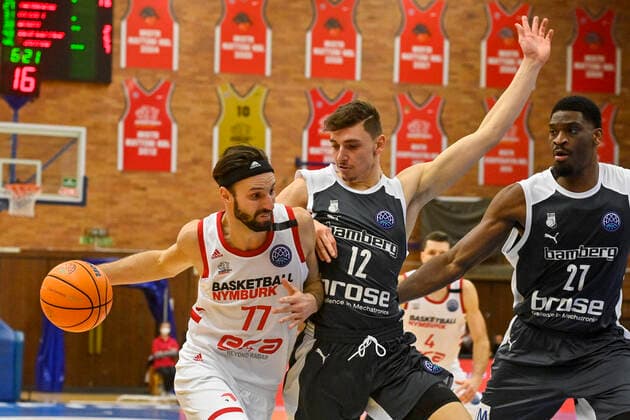 L-R Vojtech Hruban of Nymburk and Moritz Plescher and Shevon Thompson of Bamberg in action during the Men s Basketball Champions League 1st round group L match ERA Nymburk vs Brose Bamberg in Nymburk, Czech Republic, March 2nd, 2021. (CTKxPhoto VitxSimanek) CTKPhotoP202103020971301  VIS 003