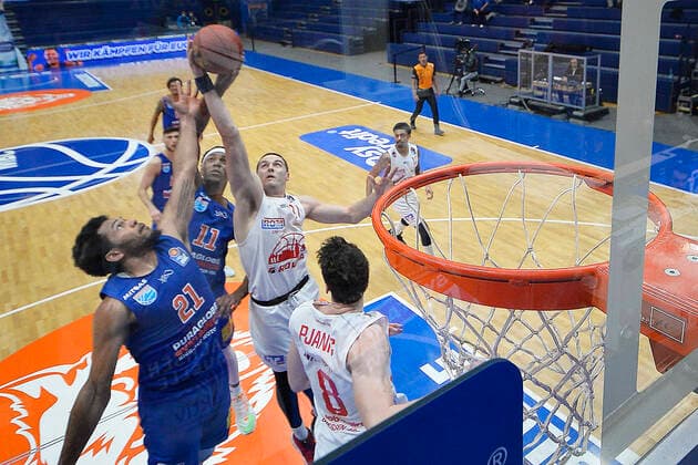 Basketball 1 Bundesliga, Season 2020 2021, 20 Matchday, Syntainics MBC Weissenfels vs JobStairs GIESSEN 46ers 03 03 2021 102 81 50 39 Quinton Hooker MBC Weissenfels, back number 21 and Kyndahl Hill MBC Weissenfels, Back number 11 against Scottie James Jr Forward Giessen 46ers, back number 31 and Alen Pjanic Forward Giessen 46ers, back number 8 at the basket during the game MBC Weissenfels vs Giessen 03 03 2021 Weissenfels Sachsen Anhalt Germany Stadthalle Weissenfels
