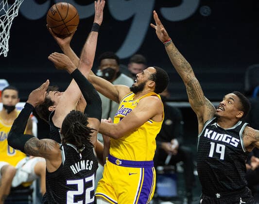 March 3, 2021, Sacramento, CA, USA: Los Angeles Lakers guard Talen Horton-Tucker (5) drives past Sacramento Kings forward Nemanja Bjelica (8) and Sacramento Kings center Richaun Holmes (22) to basket in the first quarter during a game at Golden 1 Center on Wednesday, Mar. 3, 2021 in Sacramento. Sacramento USA - ZUMAj89_ 20210303_zaf_j89_005 Copyright: xPaulxKitagakixJr.x