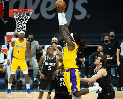 March 3, 2021, Sacramento, CA, USA: Los Angeles Lakers center Montrezl Harrell (15) dunks the ball over Sacramento Kings guard Buddy Hield (24) and Sacramento Kings forward Nemanja Bjelica (8) in the second quarter during a game at Golden 1 Center on Wednesday, Mar. 3, 2021 in Sacramento. Sacramento USA - ZUMAj89_ 20210303_zaf_j89_010 Copyright: xPaulxKitagakixJr.x