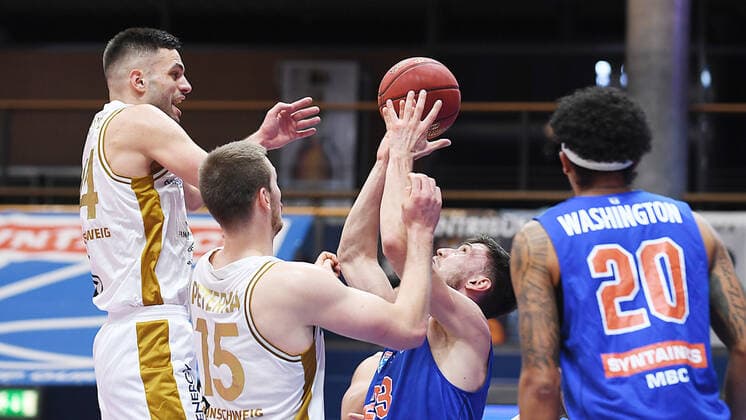 Basketball 1 Bundesliga, season 2020 2021, 22 matchday, Syntainics MBC Weissenfels vs Basketball Löwen Braunschweig 06 02 2021 Duel for the ball between Michal Michalak MBC Weissenfels, back number 23 , Benedikt Turudic Forward Braunschweig, back number 44 , Martin Peterka Center Braunschweig, back number 15 and Lukas Wank Guard Braunschweig, back number 100 during the game MBC Weissenfels vs Braunschweig 06 03 2021 Weissenfels Saxony Anhalt Germany Stadthalle Weissenfels