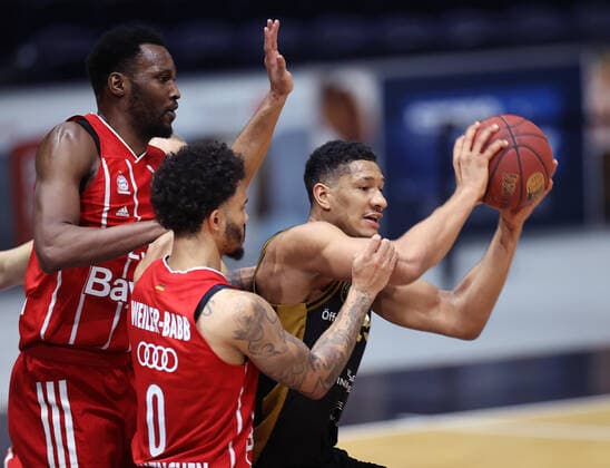 Karim Jallow Basketball Loewen Braunschweig against JaJuan Johnson FC Bayern Muenchen and Nick Weiler Babb FC Bayern Muenchen