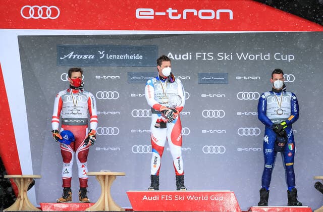 ALPINE SKIING - FIS WC Final Lenzerheide LENZERHEIDE,SWITZERLAND,17.MAR.21- ALPINE SKIING - FIS World Cup Final, award ceremony for the Downhill World Cup, men. Image shows Matthias Mayer (AUT), Beat Feuz (SUI) and Dominik Paris (ITA). Keywords: crystal globe. GEPAxpictures xMarioxBuehner
