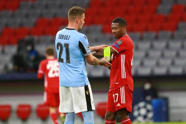 Curious 21 Sergej MilinkoviÄ‡ SaviÄ‡ Lazio Roma helps 27 David Alaba with the captains armband Football, Champions League, FC Bayern Munich Lazio Roma, 17 03 2021 PHOTO Mladen Lackovic LakoPress