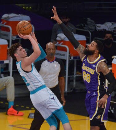 Charlotte Hornets point guard LaMelo Ball shoots over Los Angeles Lakers power forward Markieff Morris during the first half at Staples Center in Los Angeles on Thursday, March 18, 2021. The Lakers defeated the Hornets 116-105.  LAP2021031802