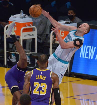 Charlotte Hornets forward Gordon Hayward is fouled by Los Angeles Lakers center Montrezl Harrell during the first half at Staples Center in Los Angeles on Thursday, March 18, 2021. The Lakers defeated the Hornets 116-105.  LAP2021031804