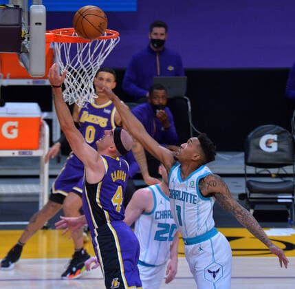 Los Angeles Lakers guard Alex Caruso scores Charlotte Hornets guard Malik Monk during the first half at Staples Center in Los Angeles on Thursday, March 18, 2021. The Lakers defeated the Hornets 116-105.  LAP2021031805