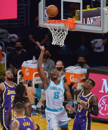 Charlotte Hornets center Bismack Biyombo scores overLos Angeles Lakers guard Dennis Schroder during the first half at Staples Center in Los Angeles on Thursday, March 18, 2021. The Lakers defeated the Hornets 116-105.  LAP2021031807