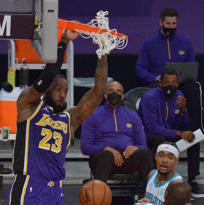 Los Angeles Lakers forward LeBron James jams for two of his 37-points on Charlotte Hornets guard Devonte Graham during the first half at Staples Center in Los Angeles on Thursday, March 18, 2021. The Lakers defeated the Hornets 116-105.  LAP2021031808