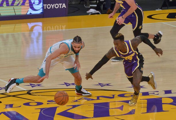 Charlotte Hornets forward Cody Martin and Los Angeles Lakers guard Dennis Schroder chase the loose ball during the first half at Staples Center in Los Angeles on Thursday, March 18, 2021. The Lakers defeated the Hornets 116-105.  LAP2021031823 JIMxRUYMEN