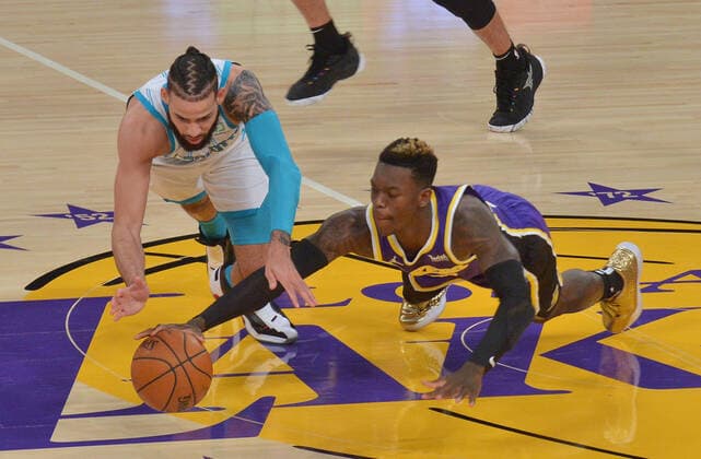 Charlotte Hornets forward Cody Martin and Los Angeles Lakers guard Dennis Schroder chase the loose ball during the first half at Staples Center in Los Angeles on Thursday, March 18, 2021. The Lakers defeated the Hornets 116-105.  LAP2021031824