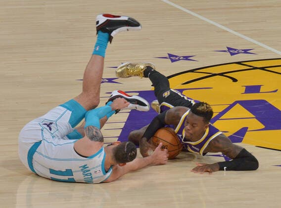 Charlotte Hornets forward Cody Martin and Los Angeles Lakers guard Dennis Schroder battle for the loose ball during the first half at Staples Center in Los Angeles on Thursday, March 18, 2021. The Lakers defeated the Hornets 116-105.  LAP2021031826 JIMxRUYMEN