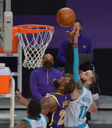 Los Angeles Lakers forward LeBron James blocks the shot by Charlotte Hornets forward Cody Martin during the first half at Staples Center in Los Angeles on Thursday, March 18, 2021. The Lakers defeated the Hornets 116-105.  LAP2021031899 JIMxRUYMEN