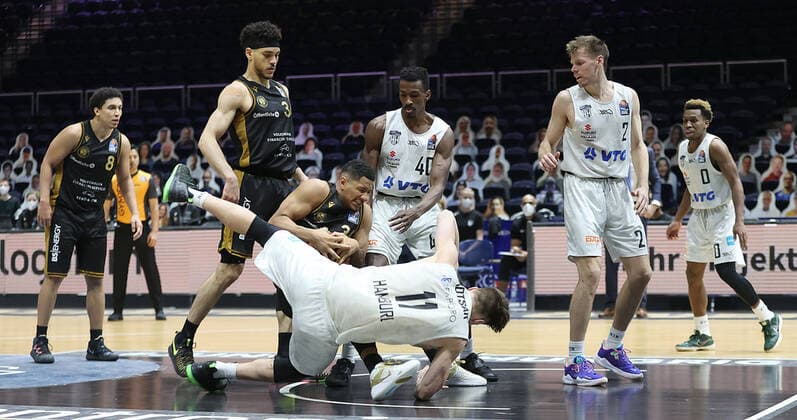 Karim Jallow Basketball Loewen Braunschweig in duel with Maik Kotsar Hamburg Towers