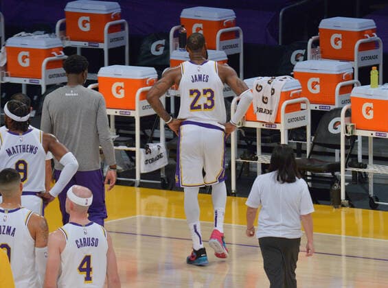 Los Angeles Lakers forward LeBron James tests his right ankle after Atlanta Hawks forward Solomon Hill slammed his body alongside James right leg for the foul during the first half at Staples Center in Los Angeles on Saturday, March 20, 2021. James reentered the game and drilled a three-pointer before asking to be taken out because of the pain to his ankle. Without James, the Lakers lost to the Hawks 99-94.  LAP2021032006 JIMxRUYMEN