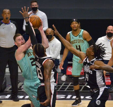 Charlotte Hornets forward Gordon Hayward looks to pass under pressure from Los Angeles Clippers forward Paul George guard Terance Mann during the first half at Staples Center in Los Angeles on Saturday, March 20, 2021. The Clippers defeated the Hornets 125-98.  LAP2021032033 JIMxRUYMEN