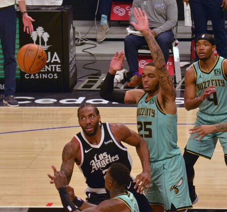 Los Angeles Clippers forward Kawhi Leonard loses control of the ball under pressure from Charlotte Hornets defenders during the second half at Staples Center in Los Angeles on Saturday, March 20, 2021. The Clippers defeated the Hornets 125-98.  LAP2021032046 JIMxRUYMEN