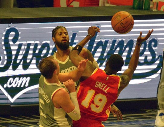 Atlanta Hawks forward Tony Snell battles Los Angeles Clippers guards Luke Kennard and Paul George for control of the offensive rebound during the fourth quarter at Staples Center in Los Angeles on Monday, March 22, 2021. The Clippers defeated the Hawks 119-110 with the comeback victory.  LAP2021032203 JIMxRUYMEN