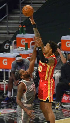 Atlanta Hawks power forward John Collins shoots over Los Angeles Clippers forward Kawhi Leonard during the fourth quarter at Staples Center in Los Angeles on Monday, March 22, 2021. The Clippers defeated the Hawks 119-110 with the comeback victory.  LAP2021032205 JIMxRUYMEN