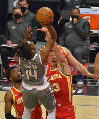 Los Angeles Clippers guard Terance Mann scores over Atlanta Hawks guard Kevin Huerter during the fourth quarter at Staples Center in Los Angeles on Monday, March 22, 2021. The Clippers defeated the Hawks 119-110 with the comeback victory.  LAP2021032208 JIMxRUYMEN