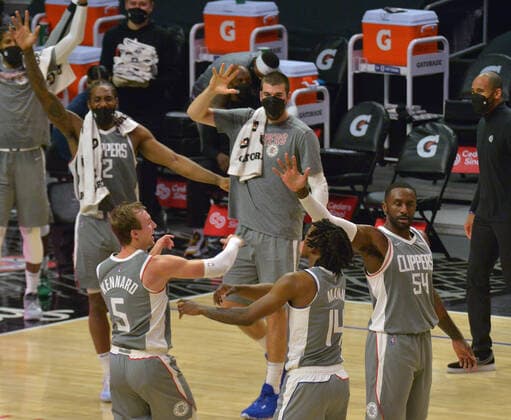 Los Angeles Clippers forward Luke Kennard (5) celebrates with his teammates after banking in a a three-pointer from halfcourt to end the third quarter against the Atlanta Hawks at Staples Center in Los Angeles on Monday, March 22, 2021. The Clippers defeated the Hawks 119-110 with the comeback victory.  LAP2021032211 JIMxRUYMEN