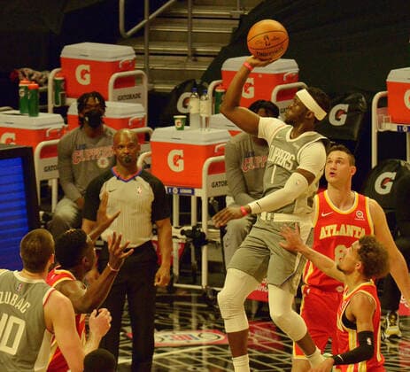 Los Angeles Clippers guard Reggie Jackson puts up a shot between a trio of Atlanta Hawks defenders during the first half at Staples Center in Los Angeles on Monday, March 22, 2021. The Clippers defeated the Hawks 119-110 with the comeback victory.  LAP2021032219 JIMxRUYMEN
