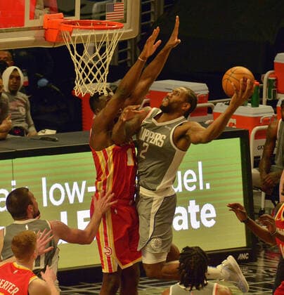 Los Angeles Clippers forward Kawhi Leonard puts up a shot against Atlanta Hawks center Clint Capela during the first half at Staples Center in Los Angeles on Monday, March 22, 2021. The Clippers defeated the Hawks 119-110 with the comeback victory.  LAP2021032229 JIMxRUYMEN