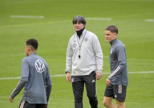 Coach Joachim Jogi LOEW Löw, GER watches Jamal MUSIALA l and Florian WIRTZ r GER during training practice mens national football team on 23 03 2021 in Duesseldorf Germany Â