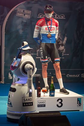 Third Mathieu van der Poel NED NL Alpecin Fenix at the award ceremony here at the winner ceremony with independent takeover of the medal from a remote controlled robot that replaces the ladies of honour podium hostesses because of the Covid 19 Corona Pandemie and the admonished contact restrictions here isolated in the sports hall of Harelbeke without spectators because of the Covid 19 Corona Pandemie Podium Award Ceremony Celebration Ceremony Joy Luck Emotion Emotion Mimic Mimic Gesture Gestic Portrait Portrait Vertical Event Event 64 E3 Saxo Bank Classic Harelbeke to Harelbeke 203 9 km Place Location Harelbeke Region West Vlaanderen Flanders Country Belgium Date 26 03 2021 Stiehl Photography