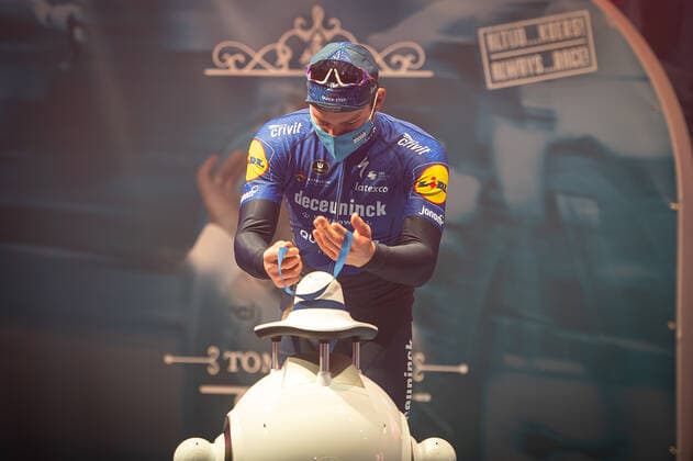Second Florian Senechal FRA Deceuninck Quick Step at the award ceremony here at the winner ceremony with independent takeover of the medal from a remote controlled robot that replaces the ladies of honour podium hostesses because of the Covid 19 Corona Pandemie and the warned contact restrictions here isolated in the sports hall of Harelbeke without spectator because of the Covid 19 Corona Pandemie Podium Award Ceremony Celebration Celebration Joy Luck Emotion Emotions Mimic Mimic Gesture Gestic Landscape landscape horizontal Event Event 64 E3 Saxo Bank Classic Harelbeke to Harelbeke 203 9 km Location Location Harelbeke Region West Vlaanderen Flanders Country Country Belgium Belgium Date Date 26 03 2021 Stiehl Photography