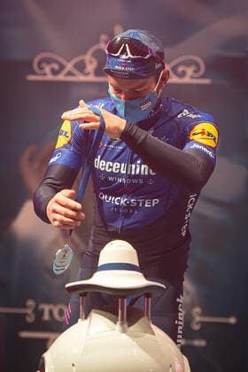Second Florian Senechal FRA Deceuninck Quick Step at the award ceremony here at the winner ceremony with independent takeover of the medal from a remote controlled robot that replaces the ladies of honour podium hostesses because of the Covid 19 Corona Pandemie and the warned contact restrictions here isolated in the sports hall of Harelbeke without spectator because of the Covid 19 Corona Pandemie Podium Award Ceremony Celebration Celebration Joy Luck Emotion Emotion Mimic Mimic Gesture Gestic Portrait Portrait Vertical Event Event 64 E3 Saxo Bank Classic Harelbeke to Harelbeke 203 9 km Place Location Harelbeke Region West Vlaanderen Flanders Country Country Belgium Belgium Date Date 26 03 2021 Stiehl Photography