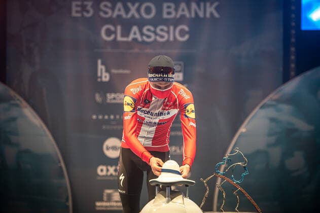 Kasper Asgreen DEN DK Deceuninck Quick Step at the award ceremony here at the winners ceremony with independent taking over of the medal from a remote controlled robot which replaces the ladies of honour podium hostesses because of the Covid 19 Corona Pandemie and the admonished contact restrictions here isolated in the sports hall of Harelbeke without spectator because of the Covid 19 Corona Pandemie Podium Award Ceremony Celebration Celebration Joy Luck Emotion Emotions Mimic Mimic Gesture Gestic Landscape landscape horizontal Event Event 64 E3 Saxo Bank Classic Harelbeke to Harelbeke 203 9 km Location Location Harelbeke Region West Vlaanderen Flanders Country Country Belgium Belgium Date Date 26 03 2021 Stiehl Photography