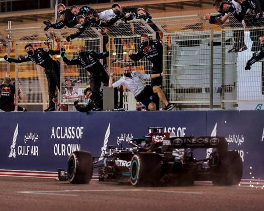March 28, 2021, Sakhir, Bahrain: Mercedes-AMG F1 team members cheer from the pit wall as LEWIS HAMILTON crosses the finish line to win the Formula One 2021 season opener Bahrain Grand Prix. Sakhir Bahrain - ZUMAg147 20210328_mda_g147_012 Copyright: xJamesxGasperottix