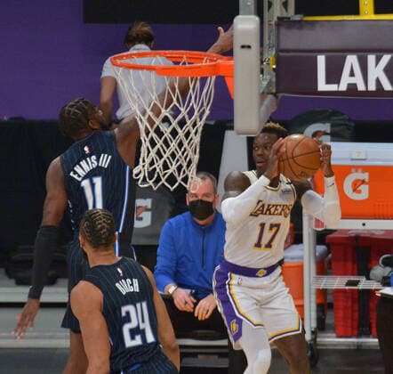 Basketball, NBA, Los Angeles Lakers - Orlando Magic Los Angeles Lakers point guard Dennis Schroder looks to pass under pressure Orlando Magic forward James Ennis III during the first half at Staples Center in Los Angeles on Sunday, March 28, 2021. The Lakers defeated the Magic 96-93.  LAP2021032804 JIMxRUYMEN