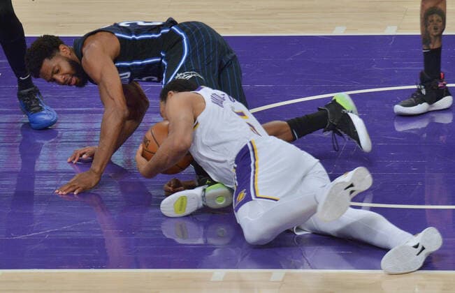 Basketball, NBA, Los Angeles Lakers - Orlando Magic Los Angeles Lakers guard Talen Horton-Tucker and Orlando Magic guard Chasson Randle battle for control of the loose ball during the first half at Staples Center in Los Angeles on Sunday, March 28, 2021. The Lakers defeated the Magic 96-93.  LAP2021032808 JIMxRUYMEN